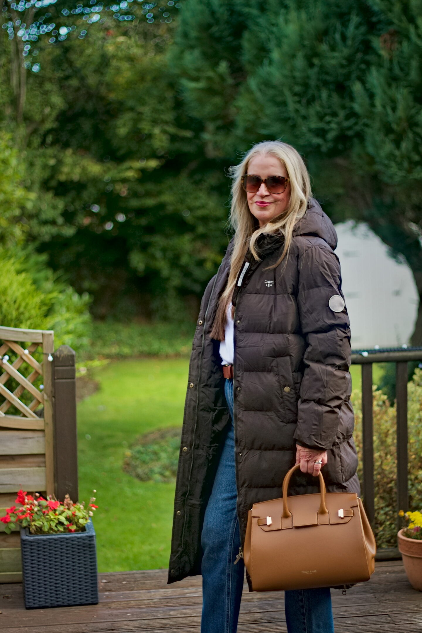 Alison from Midlife and Beyond Blog in puffer coat with handbag.
