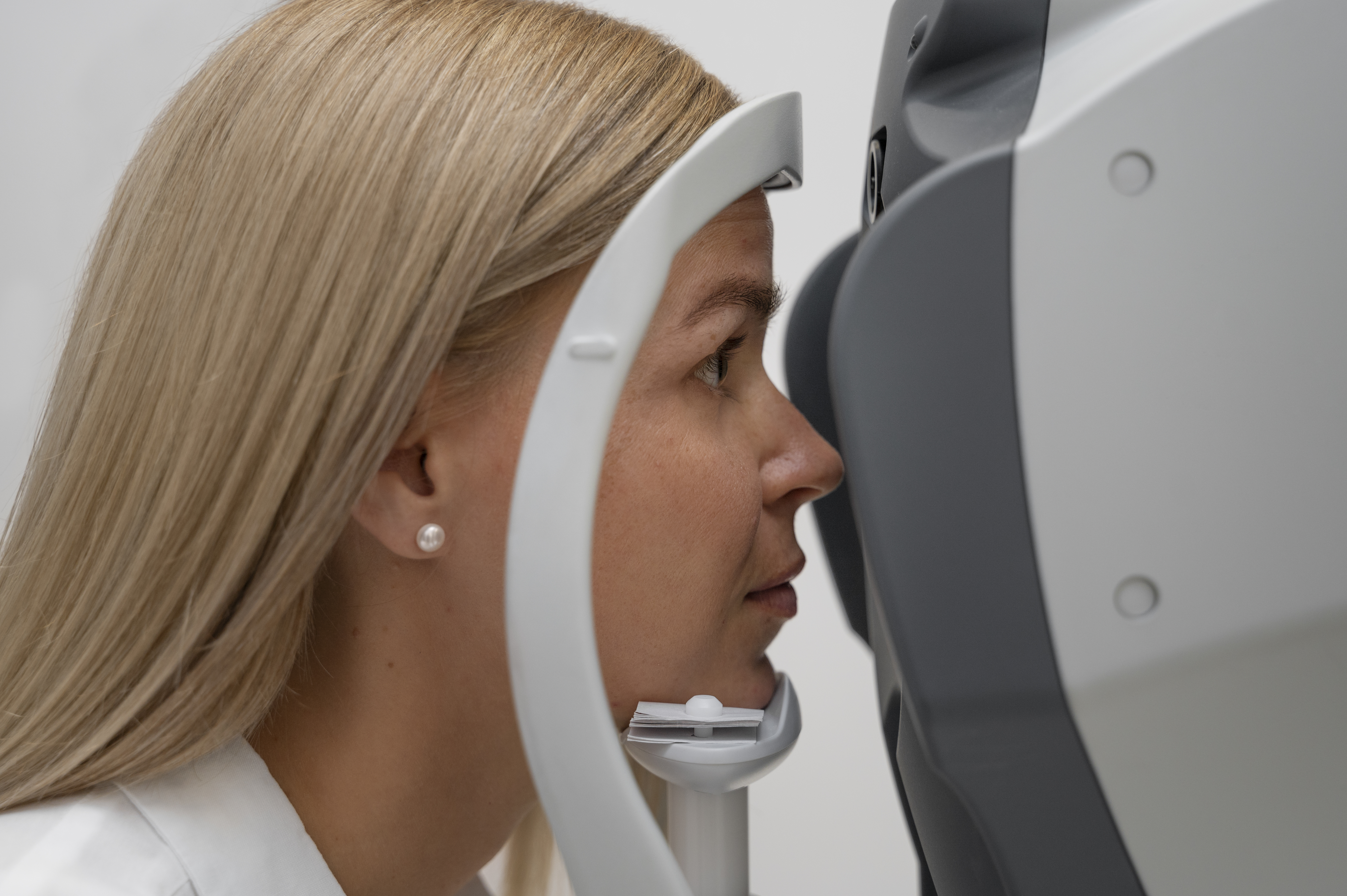 side view woman getting her eyes checked Midlife and Beyond